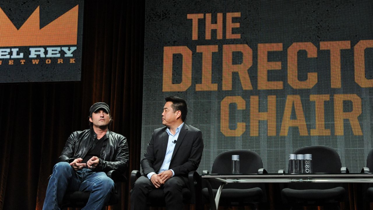 El Rey Founder/Director Robert Rodriguez, left, and Network Vice Chairman Scott Sassa speak onstage during the "The Directors Chair" segment of the El Rey Network 2014 Summer TCA. (Photo by Richard Shotwell/Invision/AP)
