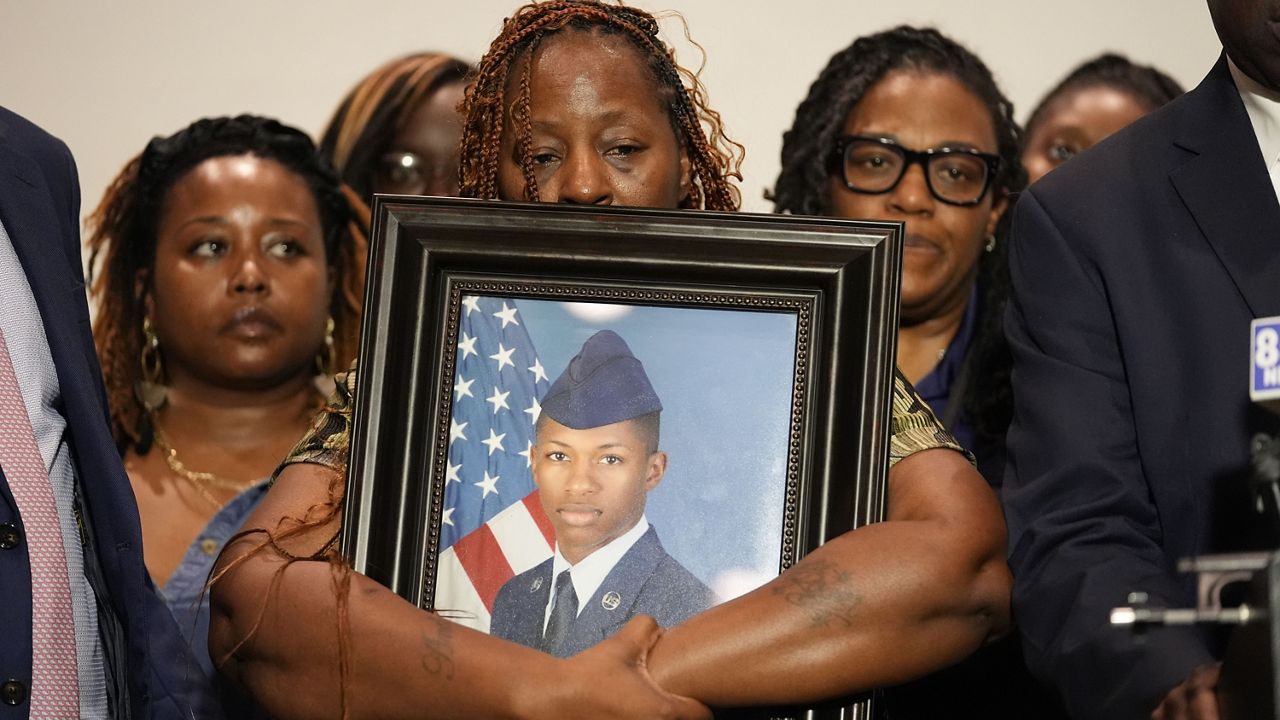 Chantemekki Fortson, mother of Roger Fortson, a U.S. Air Force senior airman, holds a photo of her son during a news conference with attorney Ben Crump, Thursday, May 9, 2024, in Fort Walton Beach, Fla. (AP Photo/Gerald Herbert)