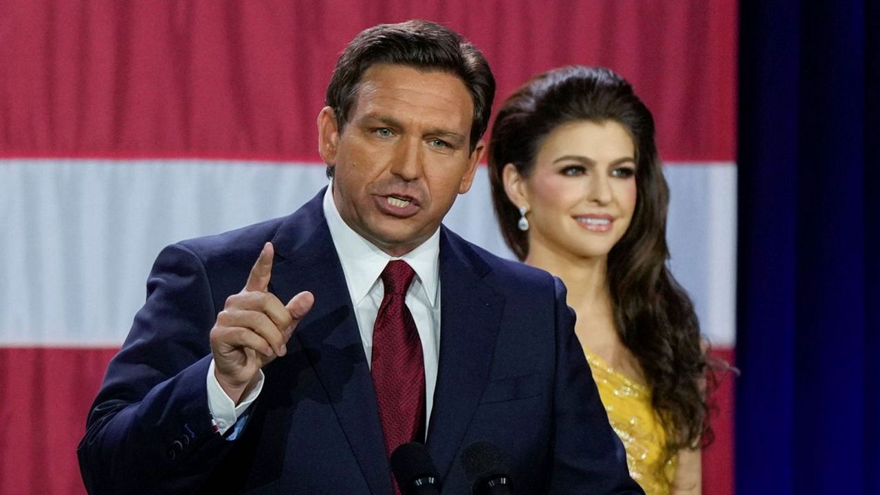 Incumbent Florida Republican Gov. Ron DeSantis speaks to supporters at an election night party after winning his race for reelection in Tampa, Fla., Tuesday, Nov. 8, 2022, as his wife Casey listens. (AP Photo/Rebecca Blackwell)
