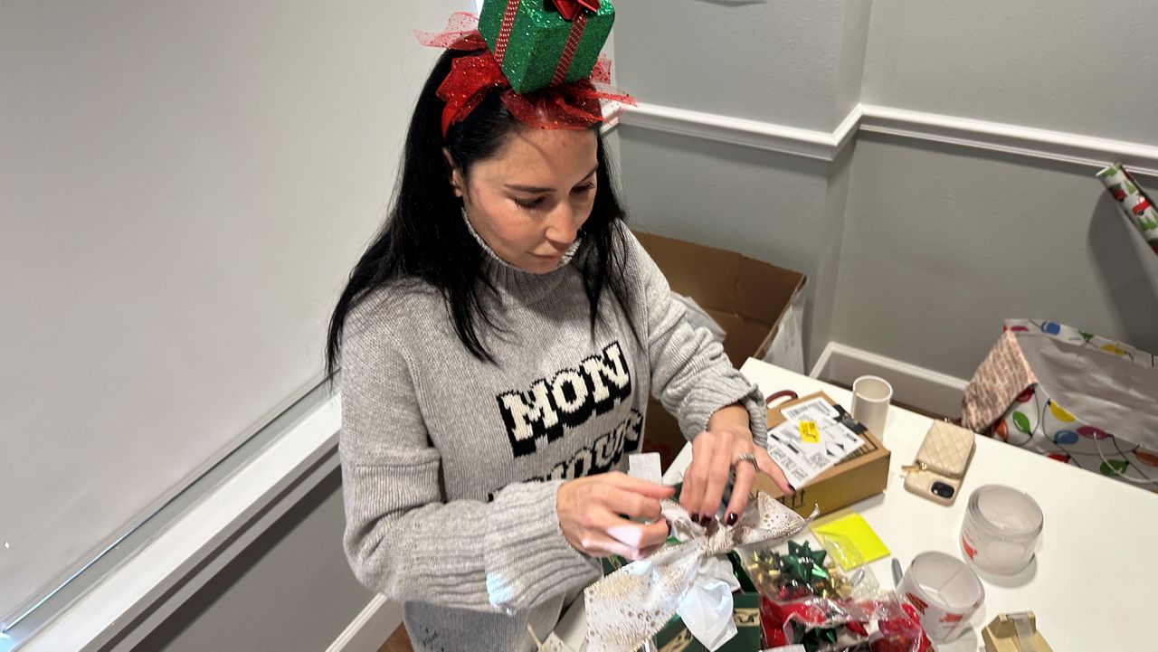 Ronnie LaValle wraps presents for families who have fallen on tough times. (Spectrum News/Asher Wildman)