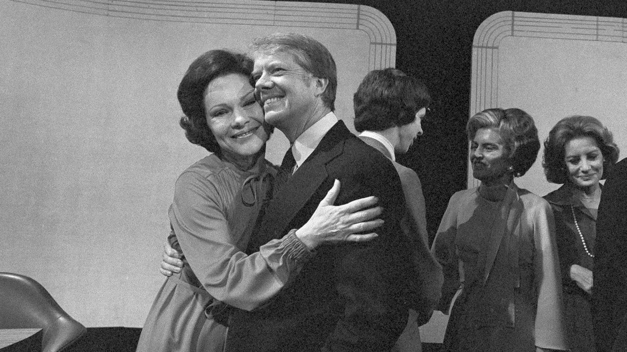 Jimmy Carter, second from left, receives a hug from his wife, Rosalynn Carter, after the third presidential debate ended, Oct. 22, 1976, in Williamsburg, Va. (AP Photo, File)