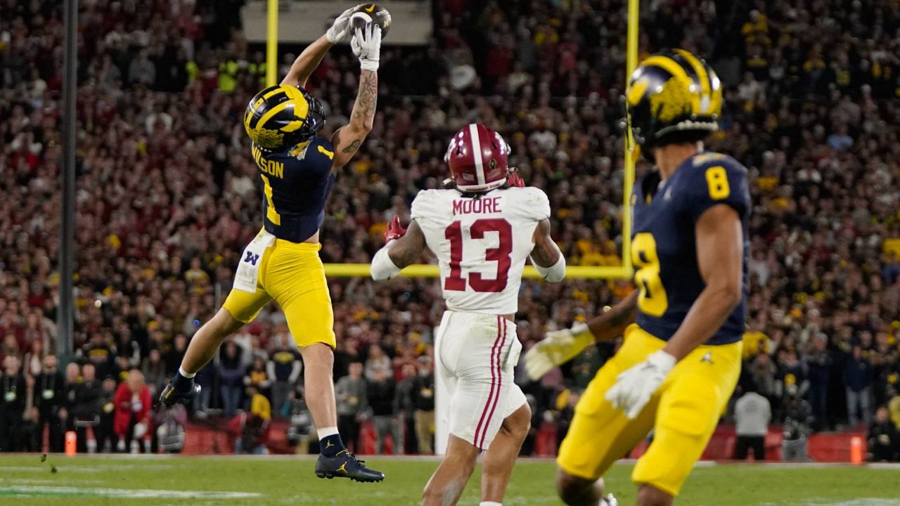 Michigan wide receiver Roman Wilson (1) makes a leaping catch during the second half in the Rose Bowl CFP NCAA semifinal college football game against Alabama Monday in Pasadena, Calif. (AP Photo/Mark J. Terrill)
