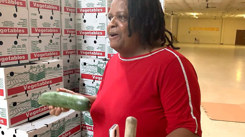 Pine Hills Pastor Rosemarie Roth helps distribute food ahead of the Thanksgiving holiday. (Spectrum News/Asher Wildman)