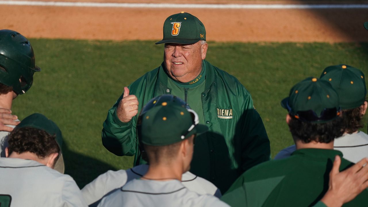 Coach with baseball players