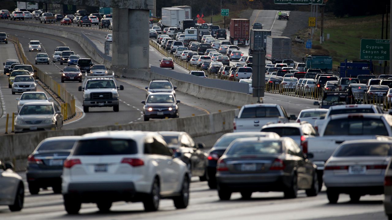 Traffic backs up after a torrent of mud and rocks covered part of State Route 91 in Orange County early Wednesday, Dec. 17, 2014, near Yorba Linda, Calif. (AP Photo/Chris Carlson)