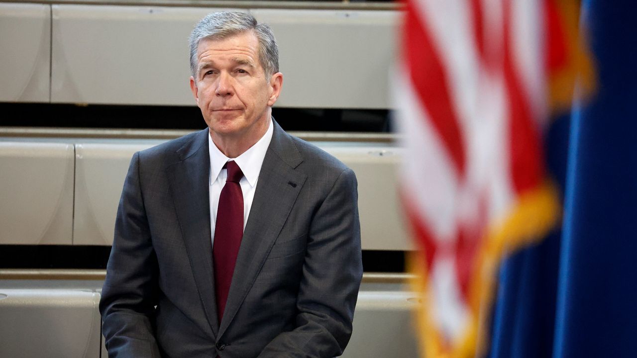 North Carolina Gov. Roy Cooper listens as Democratic gubernatorial candidate Josh Stein speaks at a rally at Shaw University in Raleigh, N.C., Tuesday, Oct. 10, 2023. (AP file photo/Karl B DeBlaker)