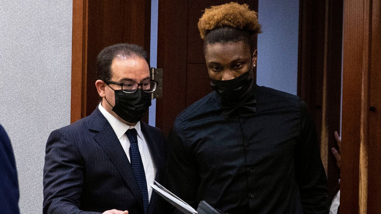 Henry Ruggs, right, former Raiders wide receiver, accused of DUI resulting in death, enters the courtroom with his attorney Richard Schonfeld, at the Regional Justice Center, Monday, Nov. 22, 2021, in Las Vegas. (Bizuayehu Tesfaye/Las Vegas Review-Journal via AP, Pool)