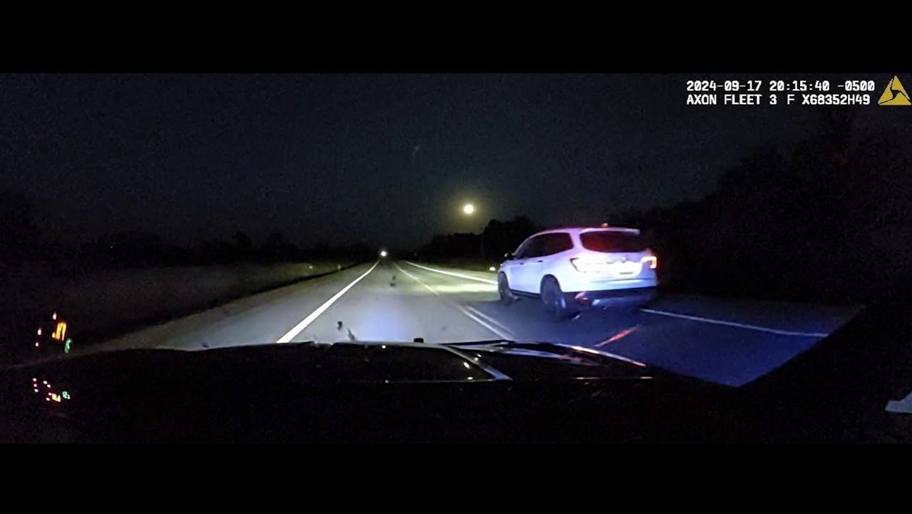 This image taken from police dash camera footage provided by the Minnesota State Patrol shows a Minnesota trooper passing 18-year-old Sam Dutcher after the Honda Pilot he was driving began to accelerate to 120 mph in western Minnesota on Tuesday, Sept. 17, 2024. (Minnesota State Patrol via AP)