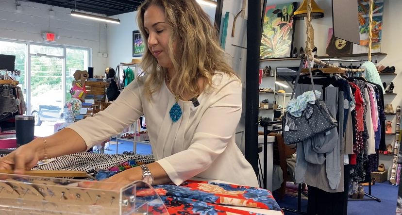 Kandice Russell arranges outfit for store display