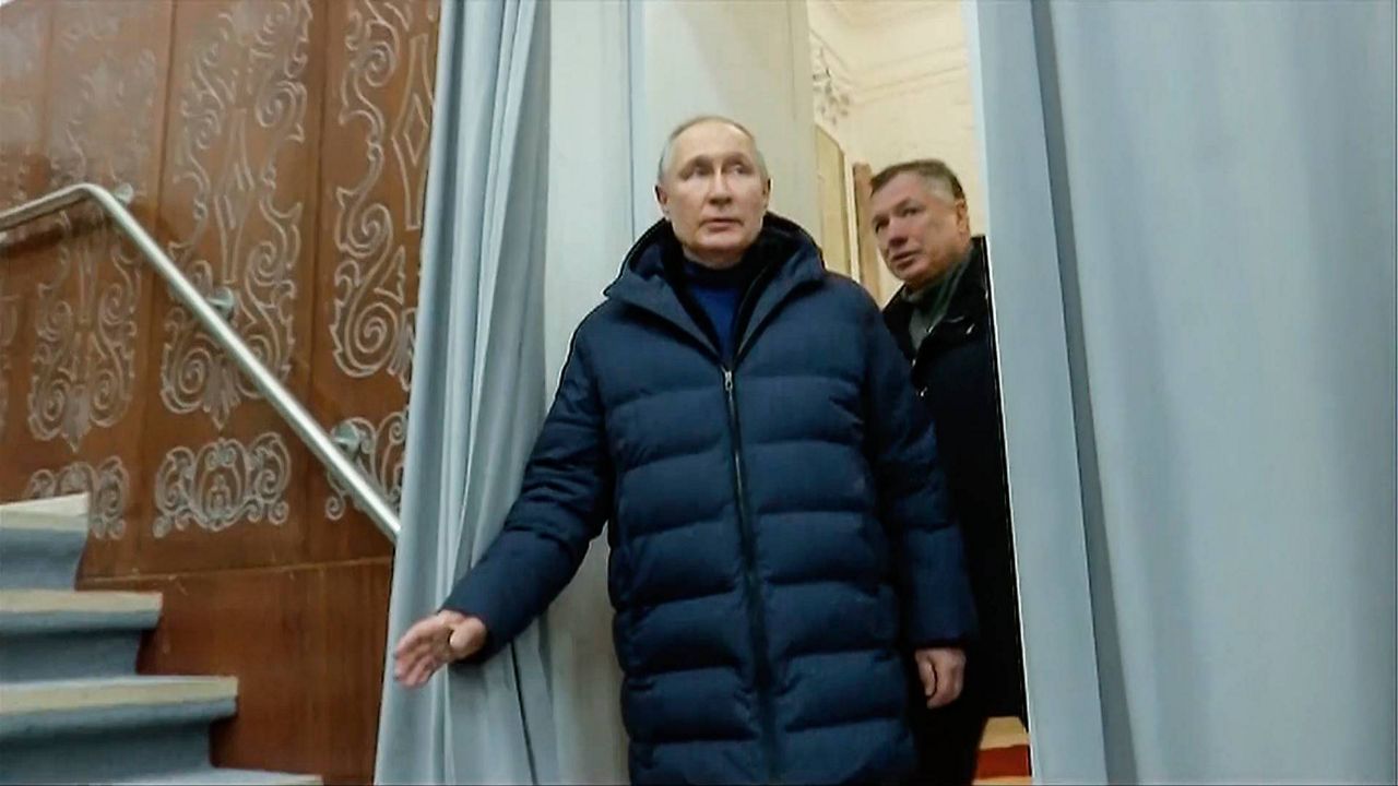 In this photo taken from video released by Russian TV Pool on Sunday, Russian President Vladimir Putin escorting by Russian Deputy Prime Minister Marat Khusnullin visits the Mariupol theater during his visit to Mariupol in Russian-controlled Donetsk region, Ukraine. (Pool Photo via AP)