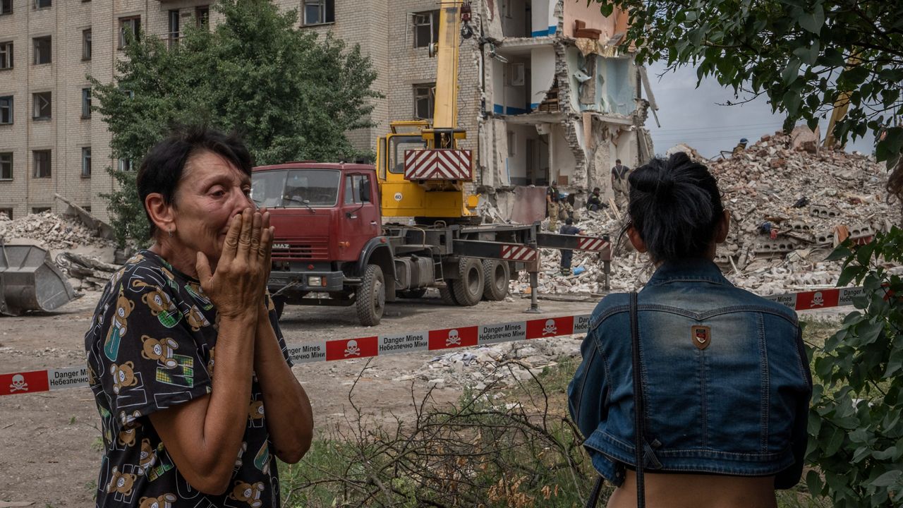 Iryna Shulimova, 59, weeps at the scene of a Russian rocket that hit an apartment residential block, in Chasiv Yar, Donetsk region, eastern Ukraine, Sunday, July 10, 2022. At least 15 people were killed and more than 20 people may still be trapped in the rubble, officials said Sunday.
