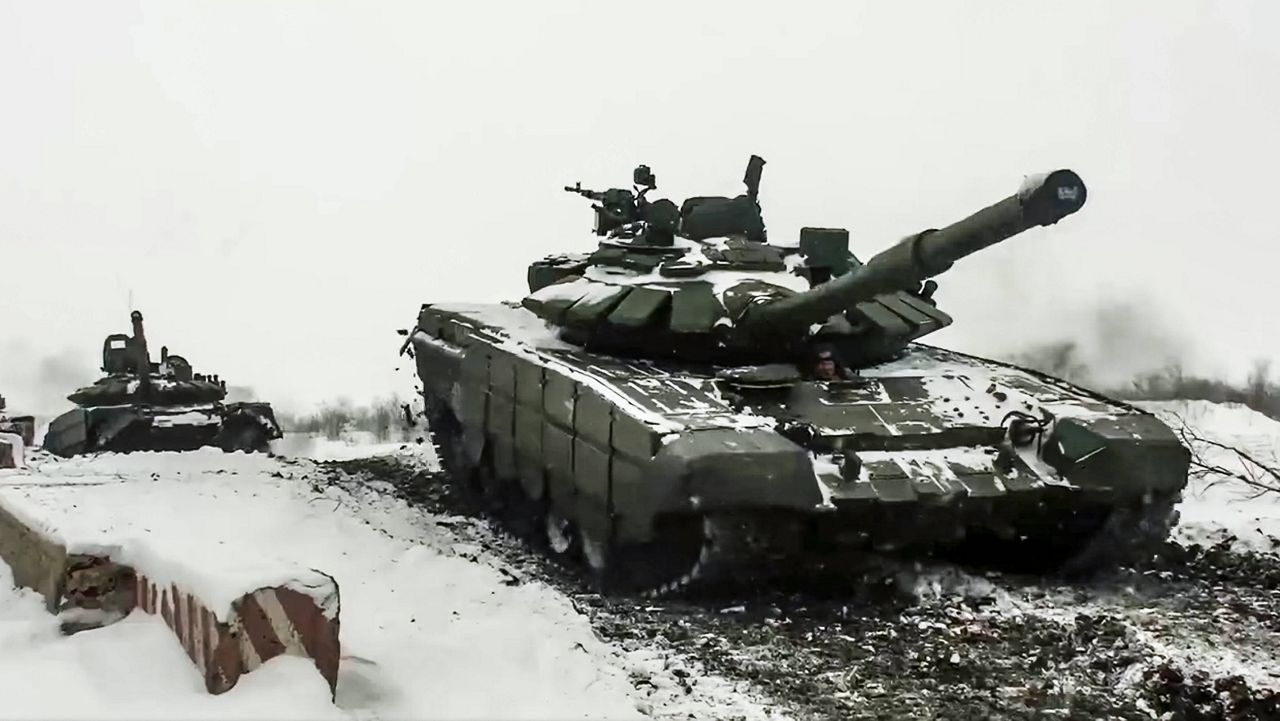 In this photo taken from video provided by the Russian Defense Ministry Press Service on Wednesday, Russian tanks roll during a military exercise at a training ground in the country's Rostov region. (Russian Defense Ministry Press Service via AP)