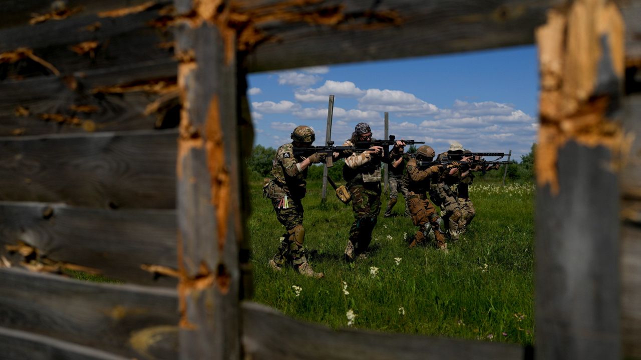 Civilian militia men hold shotguns Tuesday during training at a shooting range on the outskirts Kyiv, Ukraine. (AP Photo/Natacha Pisarenko)