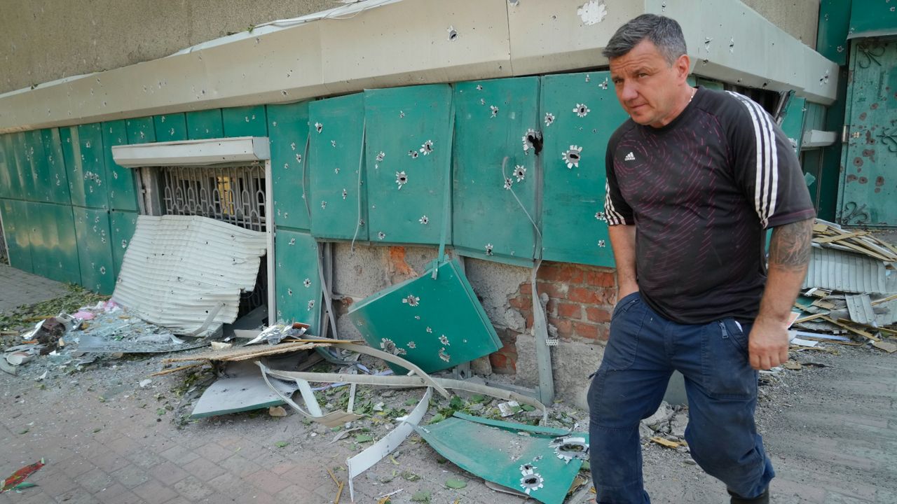 A local resident passes by shrapnel traces following Russian night shelling in the town of Bakhmut, in Ukraine's Donetsk region. (AP Photo/Efrem Lukatsky)