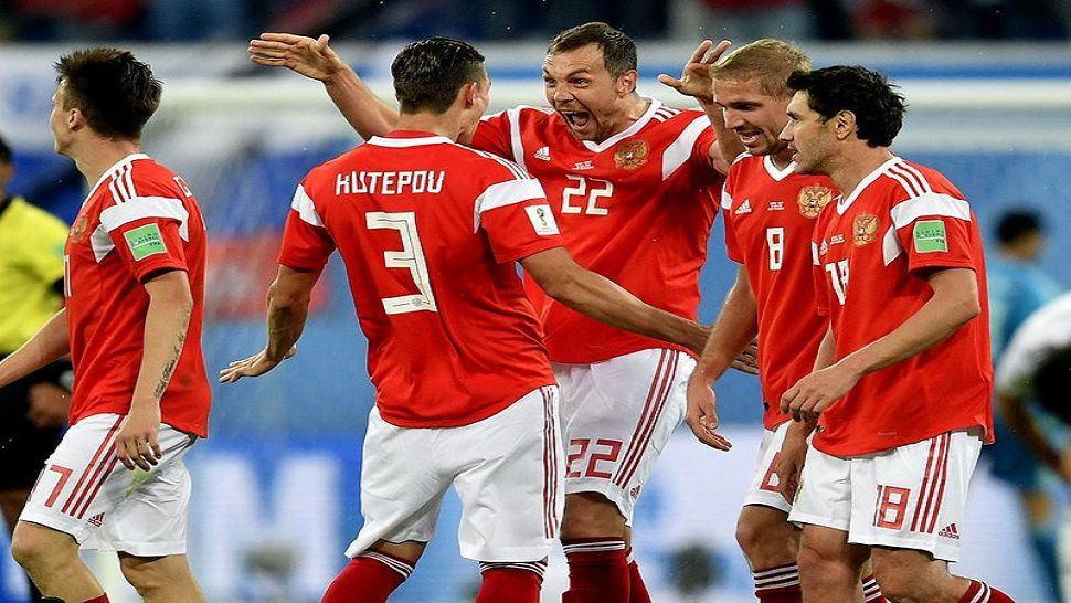 Russia’s scorer Artyom Dzyuba, center, and his teammates celebrate their side’s 3rd goal during the group A match between Russia and Egypt at the 2018 soccer World Cup in the St. Petersburg stadium in St. Petersburg, Russia, Tuesday, June 19, 2018. (AP Photo/Martin Meissner)