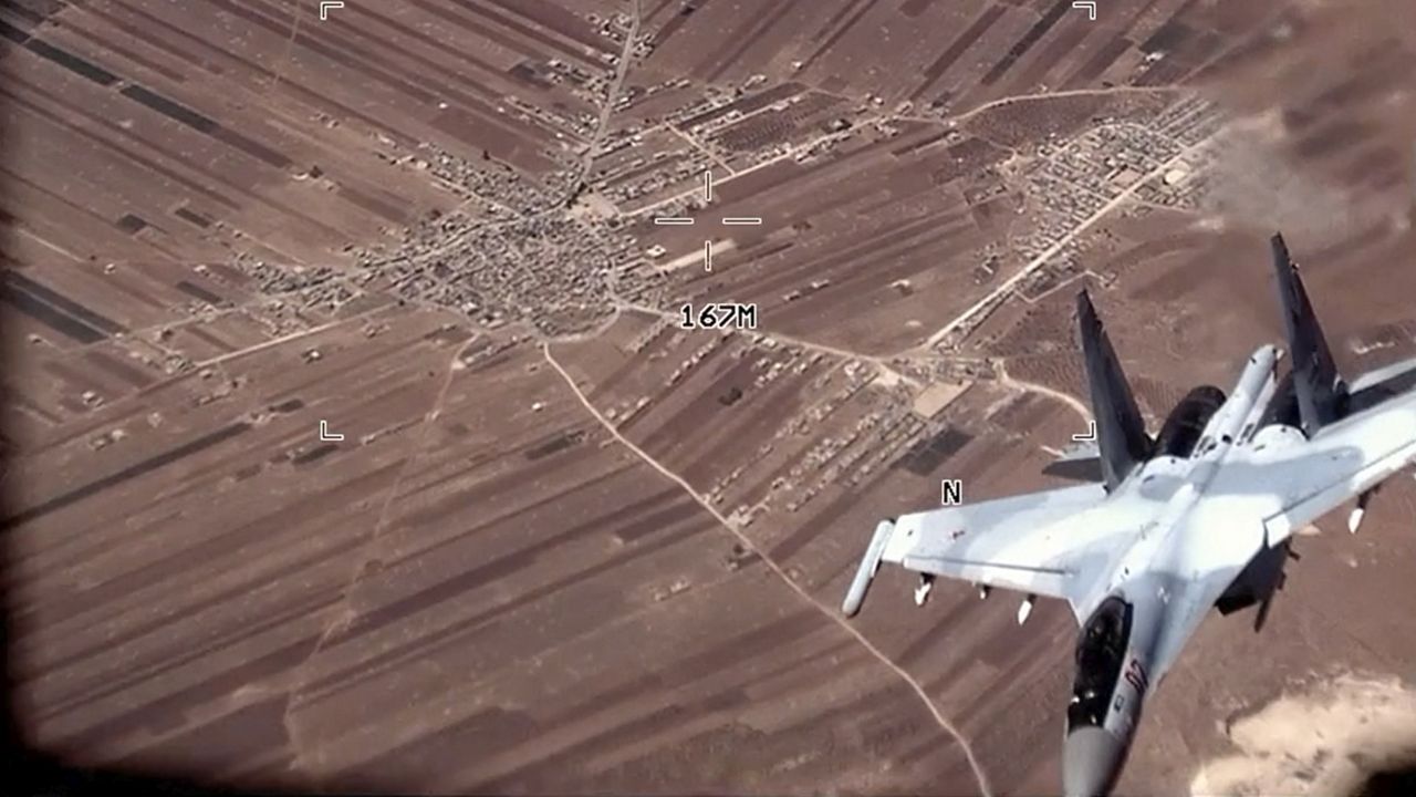 A Russian SU-35 flies near a U.S. Air Force MQ-9 Reaper drone Wednesday over. (U.S. Air Force via AP)