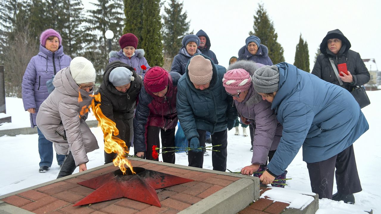 Women lay flowers in memory of those who were killed in the plane on Wednesday, at the memorial to soldiers who died in the Great Patriotic War "Enternal Flame" in Belgorod, Russia. (AP Photo)