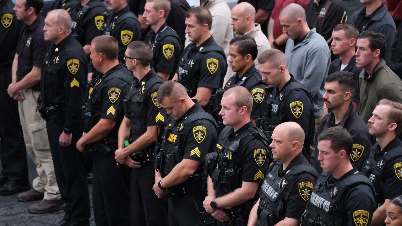 line of police officers waiting outside hospital