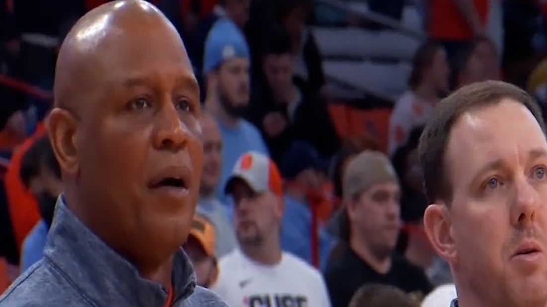Two men on sidelines.