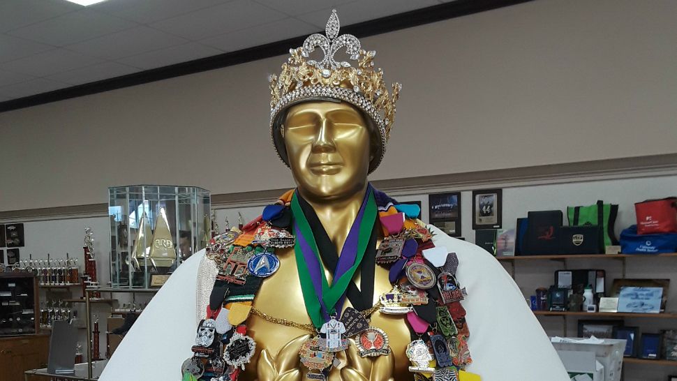 A character decked out in Fiesta medals greets customers at Monarch Trophy Studio in San Antonio in this image from April 5, 2018. (Spectrum News)