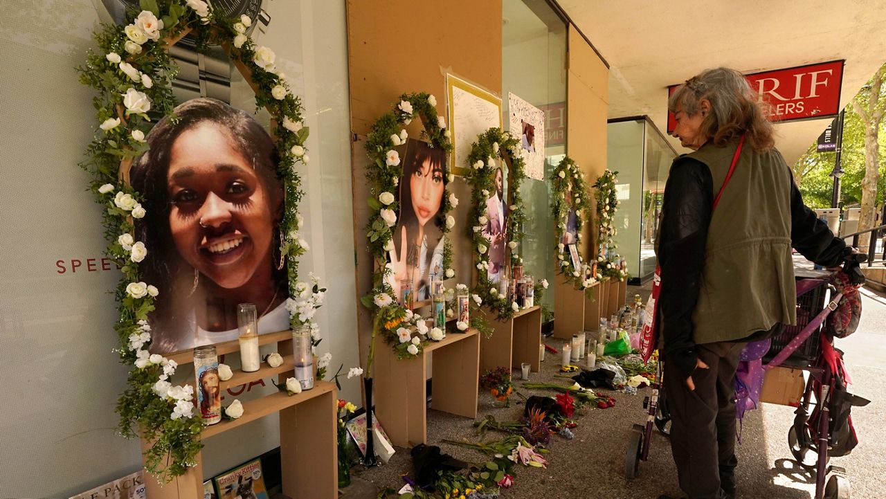 FILE - A passerby pauses at a memorial for the people killed in mass shooting in Sacramento, Calif., on April 6, 2022. (AP Photo/Rich Pedroncelli, File)