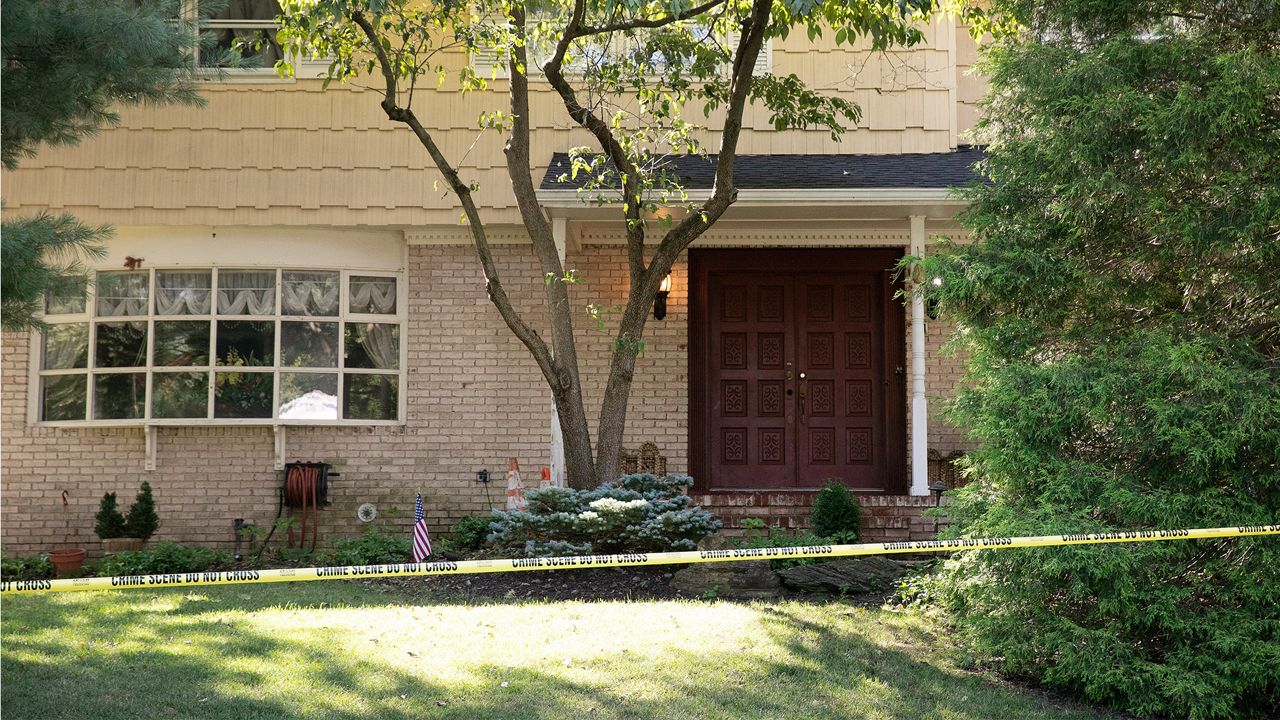 Crime scene tape surrounds the home of U.S. District Judge Esther Salas, Monday, July 20, 2020, in North Brunswick, N.J. A gunman posing as a delivery person shot and killed Salas' 20-year-old son and wounded her husband Sunday evening at their New Jersey home before fleeing, according to judiciary officials. (AP Photo/Mark Lennihan)