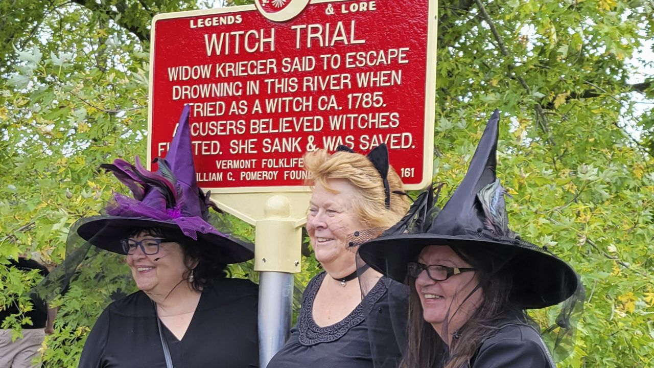 In this Sept. 16, 2023 photo, provided by Alexina Jones, people dressed as witches gather near a newly installed marker, in Pownal, Vt., that recognizes the survivor of Vermont's only recorded witch trial. Widow Krieger was said to have escaped drowning in the Hoosic River when tried as a witch in 1785, according to the Legends and Lore marker. (Alexina Jones via AP)