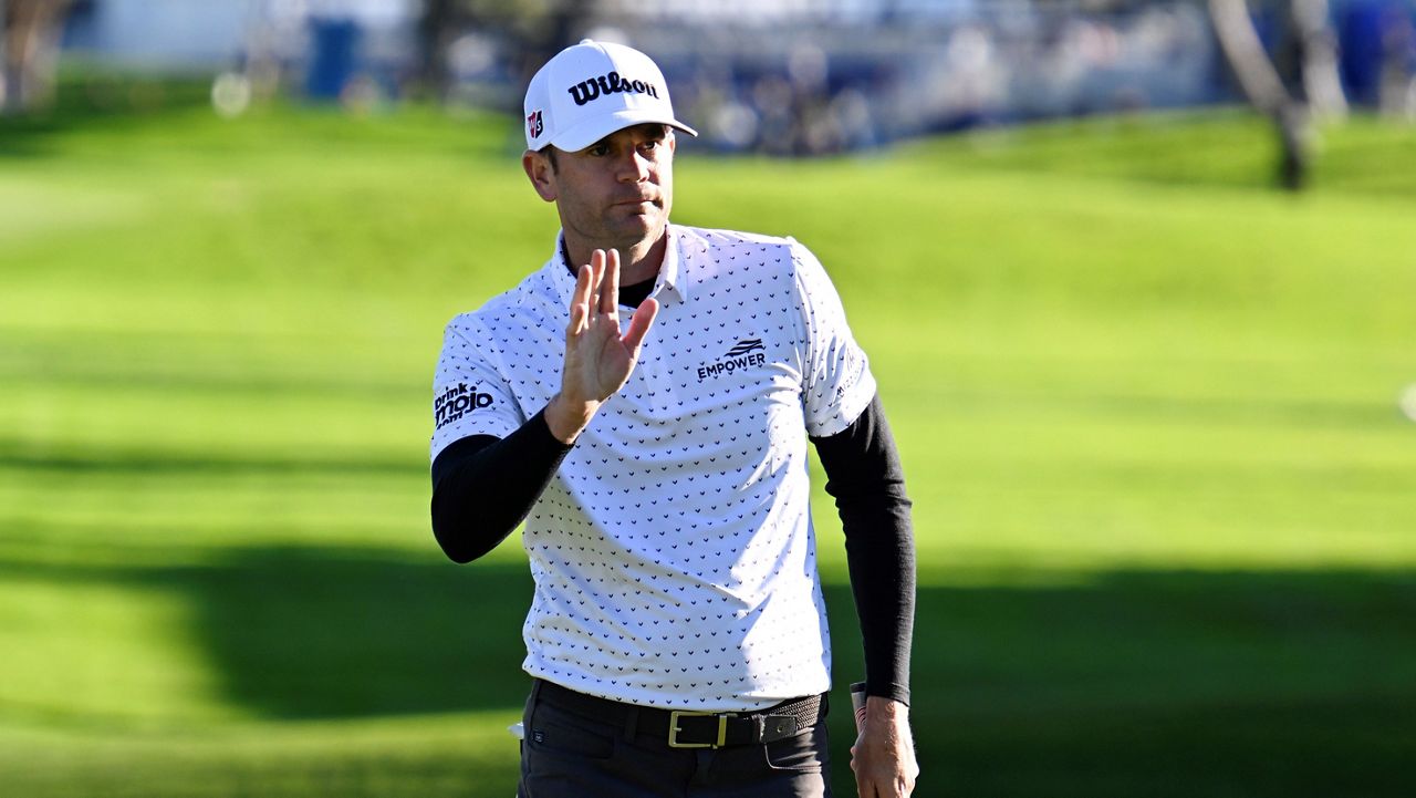 Sam Ryder acknowledges the gallery after finishing his round on the 18th hole of the South Course at Torrey Pines during the second round of the Farmers Insurance Open golf tournament, Thursday, Jan. 26, 2023, in San Diego. (AP Photo/Denis Poroy)