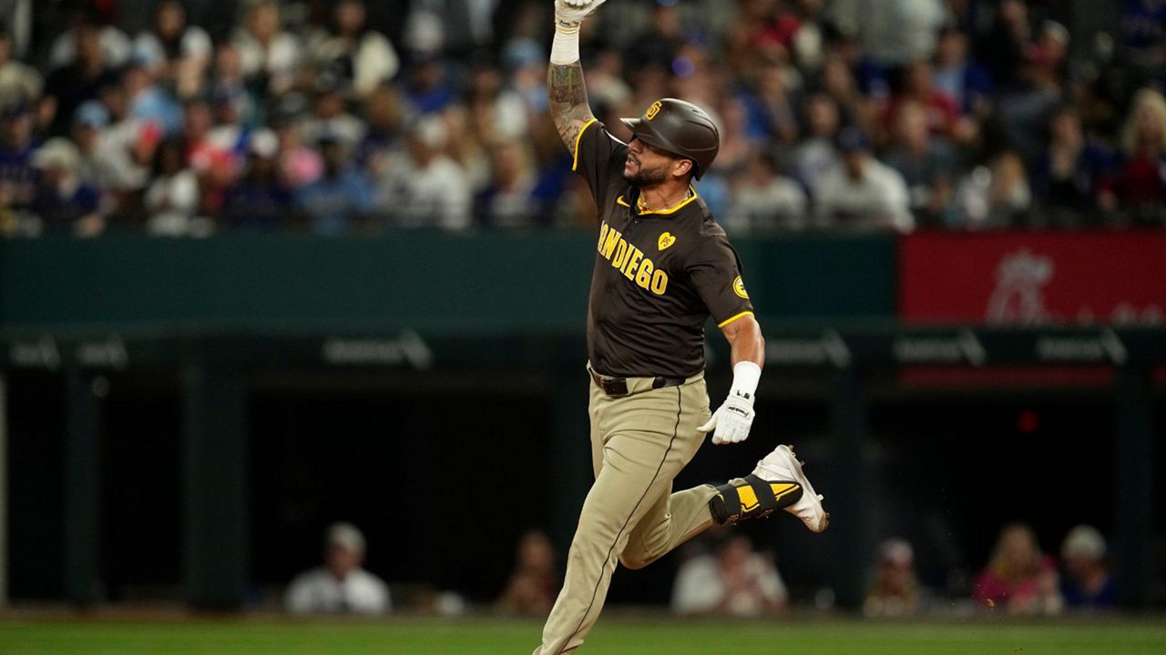 San Diego Padres' David Peralta celebrates his two-run home run against the Texas Rangers in the seventh inning of a baseball game Wednesday, July 3, 2024 in Arlington, Texas. (AP Photo/Tony Gutierrez)