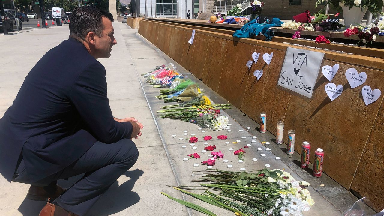 FILE - San Jose Mayor Sam Liccardo stops to view a makeshift memorial for the rail yard shooting victims in front of City Hall in San Jose, Calif., on May 27, 2021. (AP Photo/Haven Daley, File)