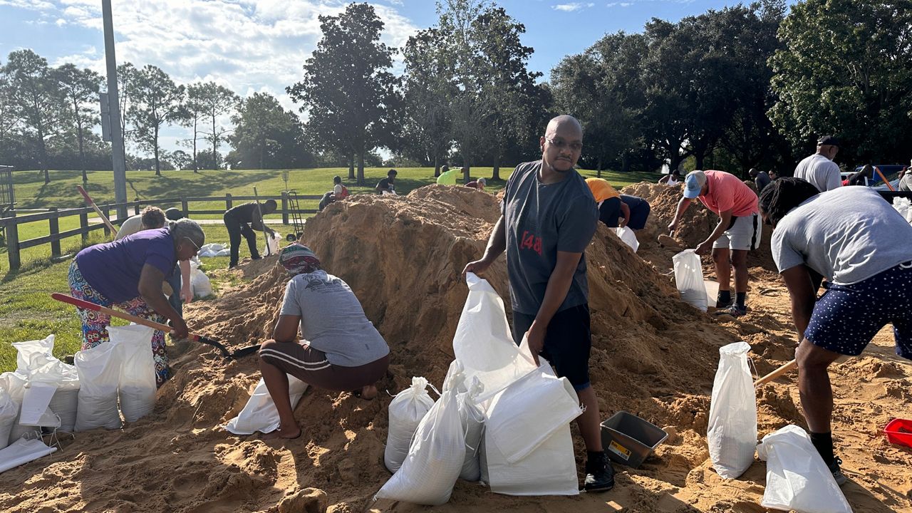 More than 2 dozen people filled up sandbags at Barnett Park in Orlando on Wednesday to take away and use to help protect their homes from possible flooding related to Helene. (Spectrum News/Jaclyn Harold)