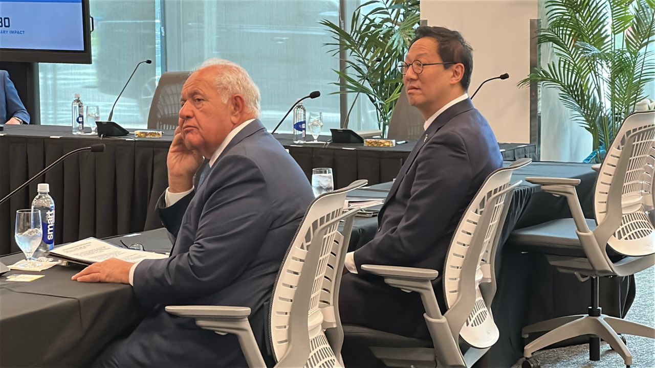 Santa Ono (right) and Mori Hosseini (left), chairman of the UF Board of Trustees, sit at a confirmation meeting where Ono was rejected to become president of the University of Florida. (Spectrum News/Nick Allen)