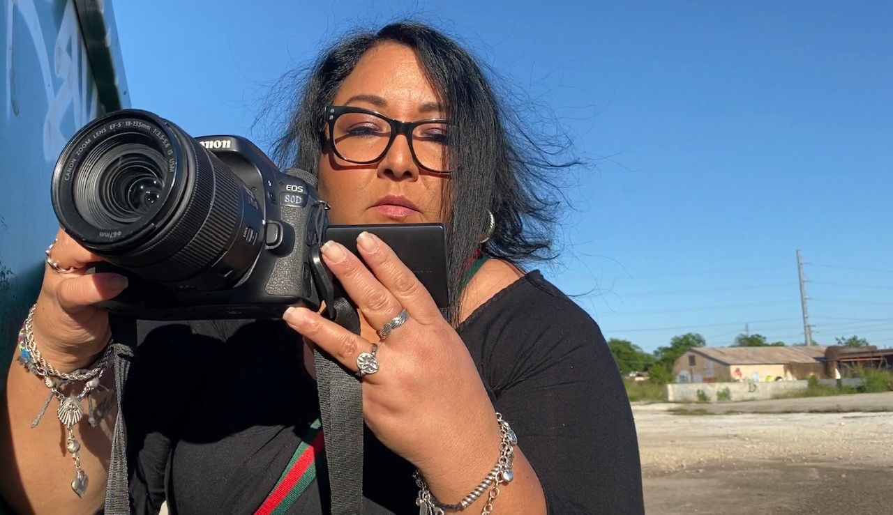 Carmen Pena snaps a photo in the downtown San Antonio area. (Spectrum News 1/Jose Arredondo)