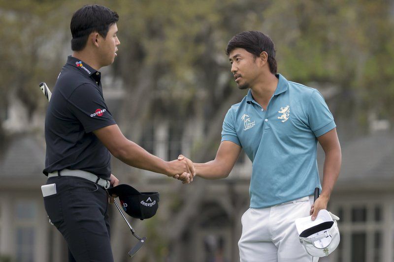 Satoshi Kodaira, right, of Japan, shakes hands with Si Woo Kim, left, of South Korea, fter sinking a birdie putt on the 17th green during a three-hole playoff in the final round of the RBC Heritage golf tournament in Hilton Head Island, S.C., Sunday, April 15, 2018. (AP Photo/Stephen B. Morton)