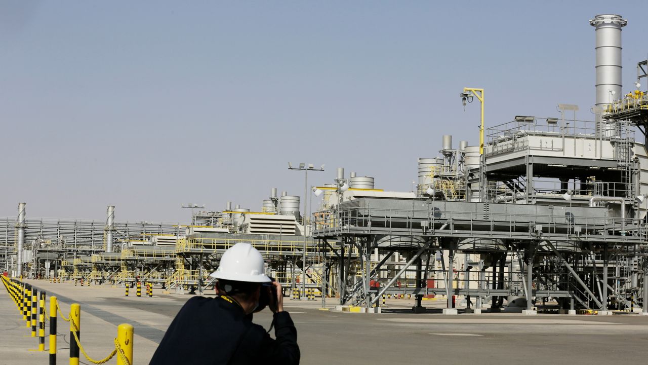 A photographer takes pictures of the Khurais oil field during a tour for journalists, 150 km east-northeast of Riyadh, Saudi Arabia, June 28, 2021.  (AP/Amr Nabil)