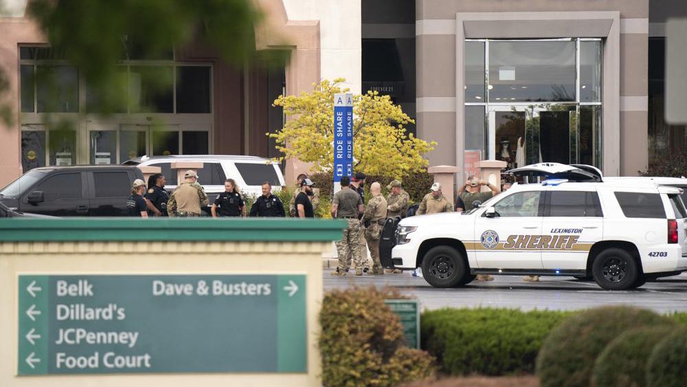 Members of law enforcement gather outside Columbiana Centre mall in Columbia, S.C., following a shooting, April 16, 2022. Authorities in South Carolina say they are investigating shooting at a club in Hampton County early Sunday, April 17, 2022 that left at least nine people injured. It was the second mass shooting in the state in as many days. (AP Photo/Sean Rayford)