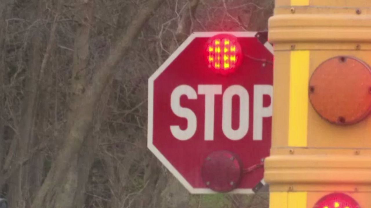 Reminder: You need to stop when a school bus is stopped with flashing lights and the stop sign out. (File)