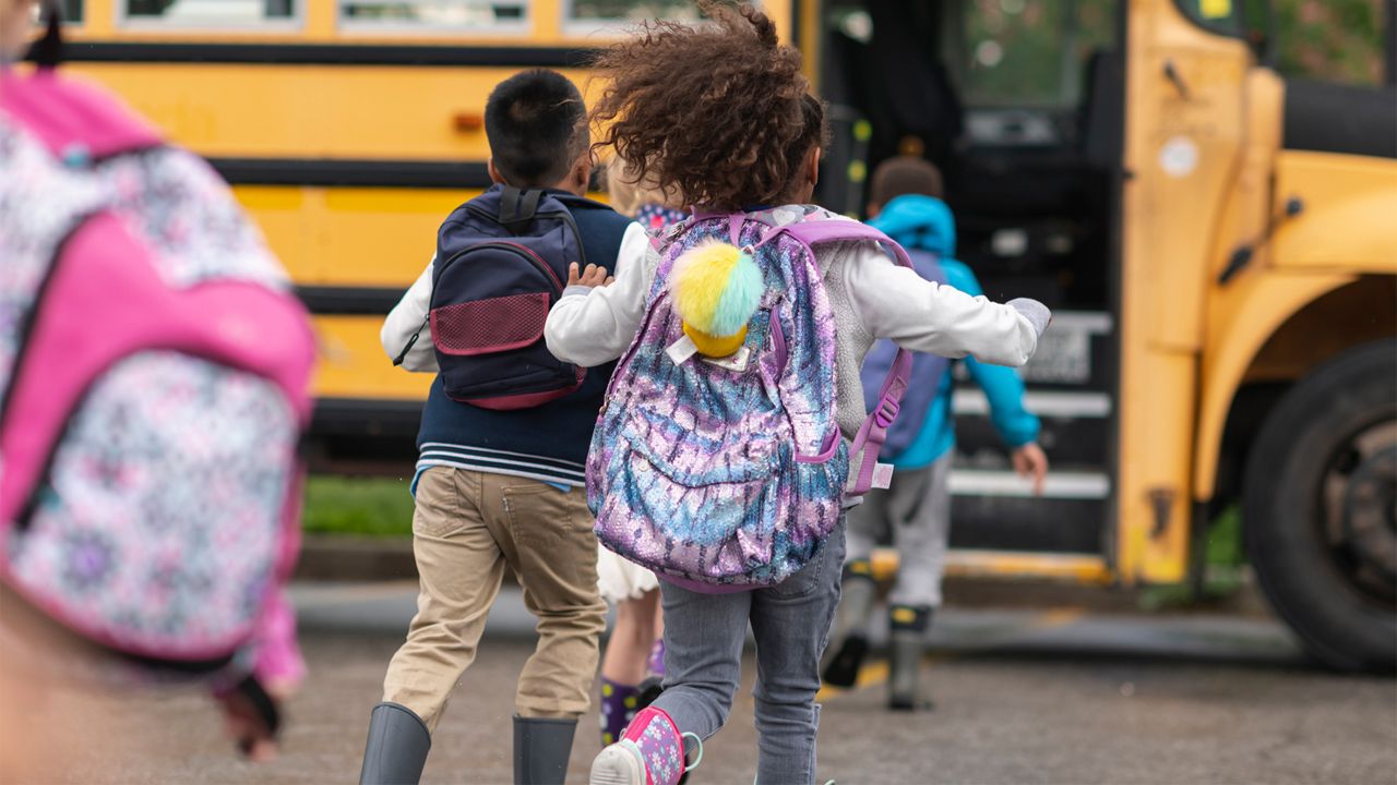 Children running to enter a school bus (Spectrum News/File)