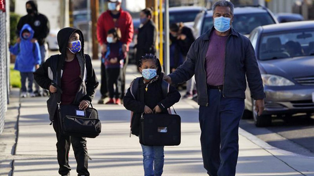 In this Feb. 25, 2021 file photo students are dropped off at Newhall Elementary School in Santa Clarita, Calif.  (AP Photo/Marcio Jose Sanchez, File)