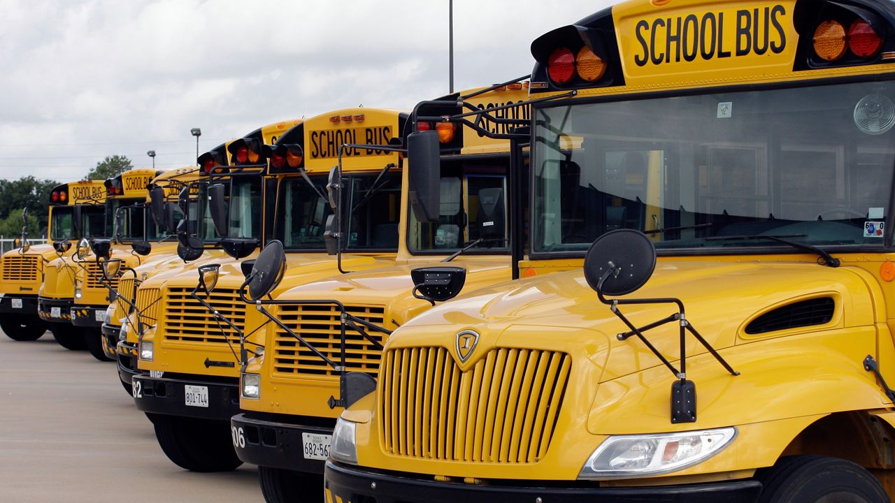 Buses are parked in a row at a Cypress-Fairbanks Independent School District transportation center Friday, Aug. 7, 2009 in Houston. (AP Photo/David J. Phillip)