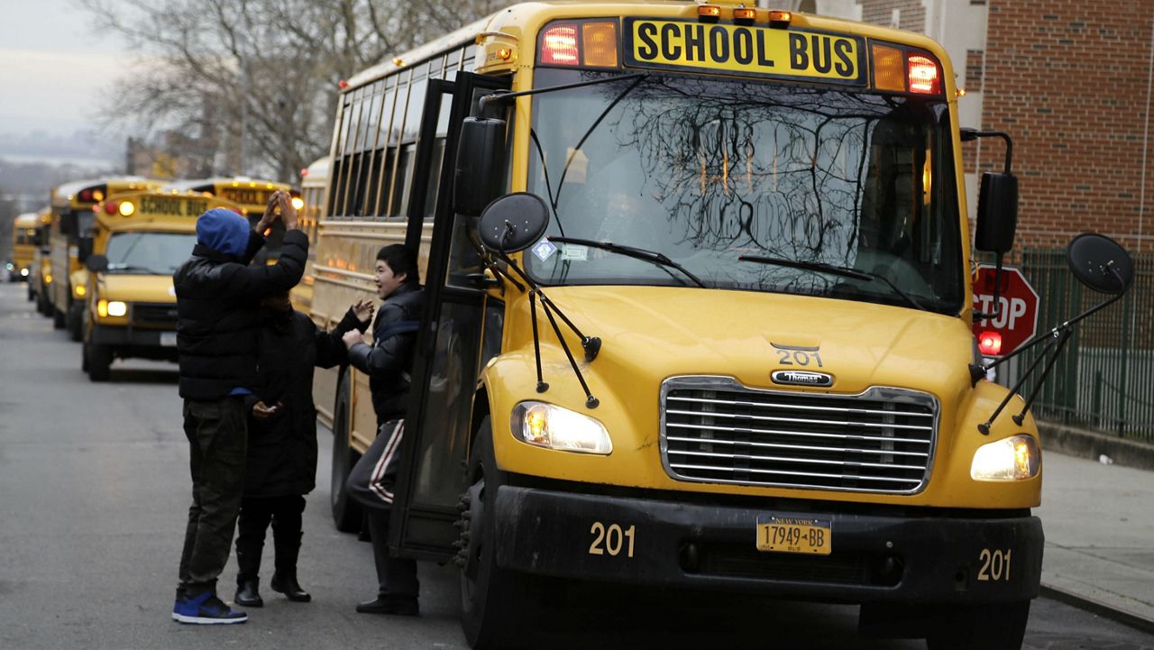FILE - Students exiting a school bus. (AP Photo/Seth Wenig, File)