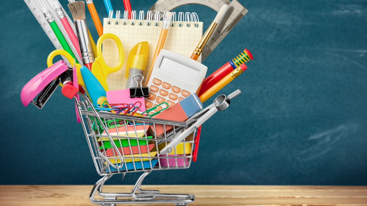 Artistic shot of school supplies in a mini shopping cart (Getty Images)