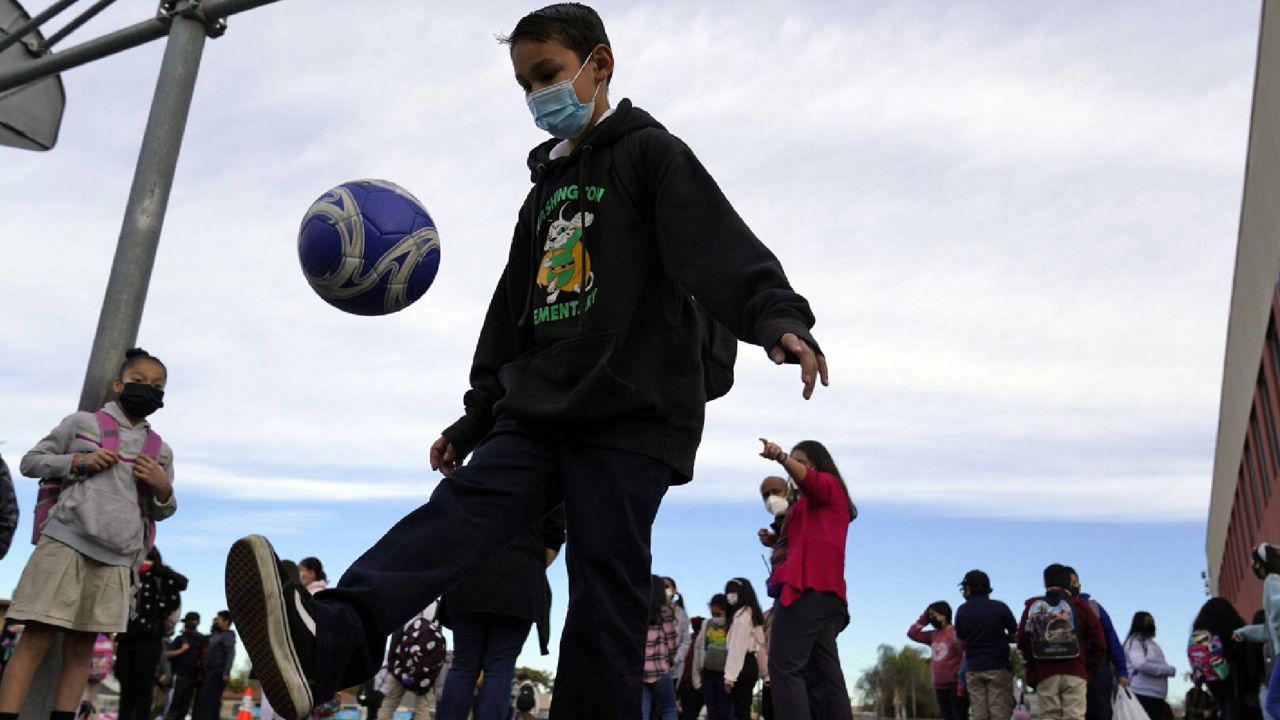 FILE - A student juggles a soccer ball on a playground amid the COVID-19 pandemic at Washington Elementary School Wednesday, Jan. 12, 2022, in Lynwood, Calif. (AP Photo/Marcio Jose Sanchez)