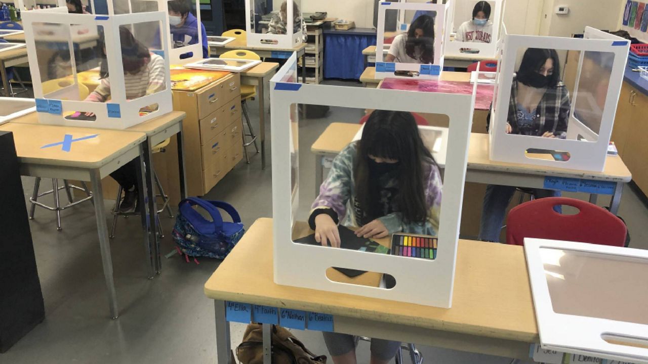 FILE - In this March 2, 2021, file photo, socially distanced and with protective partitions students work on an art project during class at the Sinaloa Middle School in Novato, Calif. (AP Photo/Haven Daley, File)