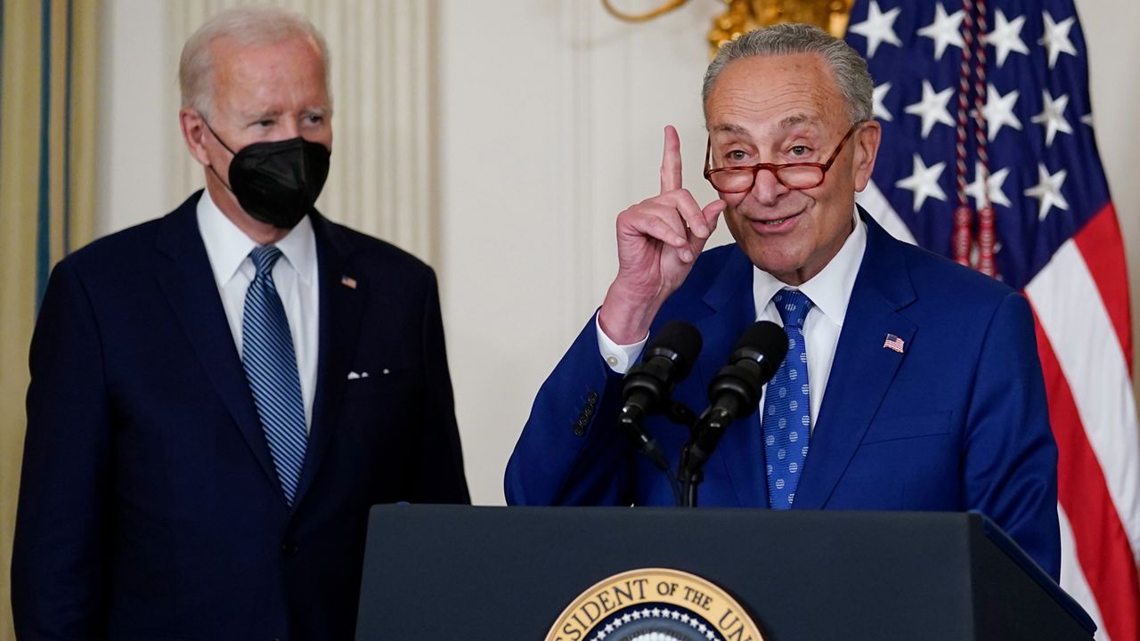 President Joe Biden listens as Senate Majority Leader Chuck Schumer of N.Y., speaks on Aug. 16, 2022. (AP Photo/Susan Walsh)