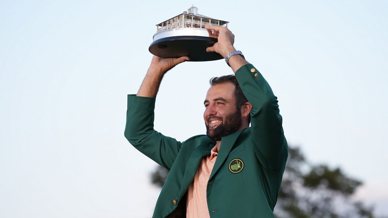 Scottie Scheffler holds the trophy after winning the Masters golf tournament at Augusta National Golf Club Sunday, April 14, 2024, in Augusta, Ga. (AP Photo/Matt Slocum)