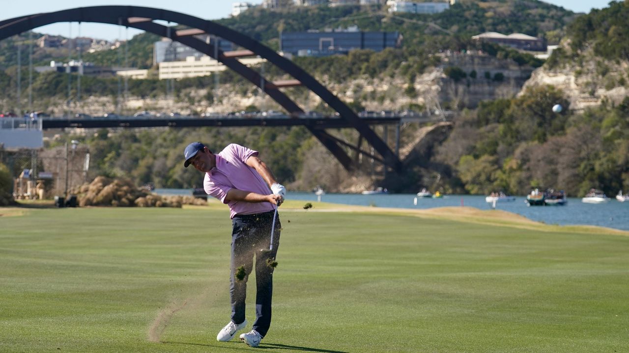 Scottie Scheffler hits his approach on the 14th hole in the final round of the Dell Technologies Match Play Championship golf tournament, Sunday, March 27, 2022, in Austin, Texas. (AP Photo/Tony Gutierrez)