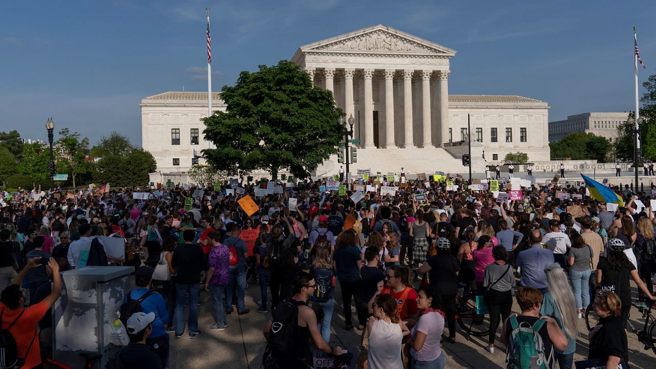 Demonstrators protest outside of the U.S. Supreme Court Tuesday in Washington. (AP Photo/Jose Luis Magana)