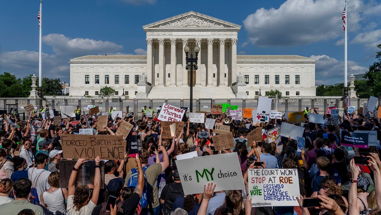 Abortion-rights and anti-abortion demonstrators gather outside of the Supreme Court in Washington, Friday, June 24, 2022. (AP Photo/Gemunu Amarasinghe)