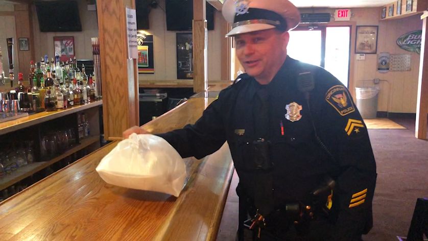 A Cincinnati Police officer picks up his free meal from Jim and Jack's